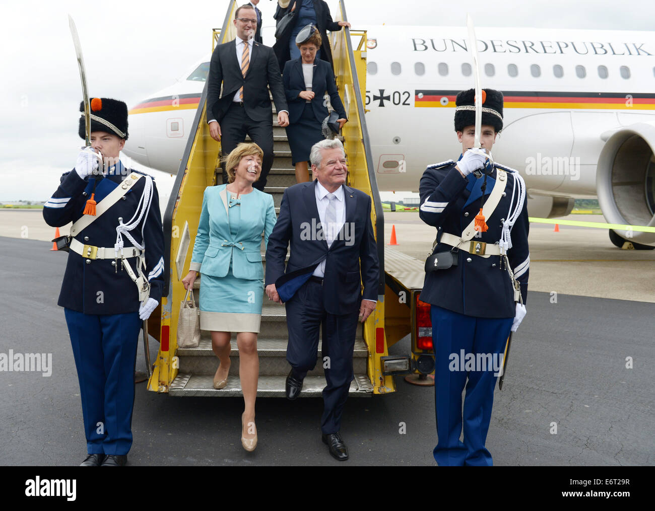 Maastricht, Germany. 30th Aug, 2014. German President Joachim Gauck and his partner Daniela Schadt alight from a government plane at Maastricht-Aachen Airport in Maastricht, Germany, 30 August 2014. The attend the festivities on the occasion of the 200th jubilee of the Kingdom of the Netherlands. Photo: RAINER JENSEN/DPA/Alamy Live News Stock Photo