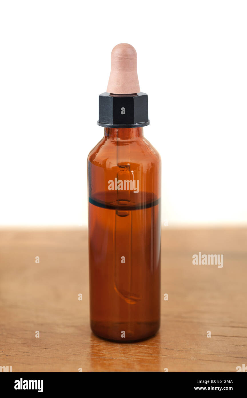 Herbal medicine or aromatherapy dropper bottle on wood Stock Photo