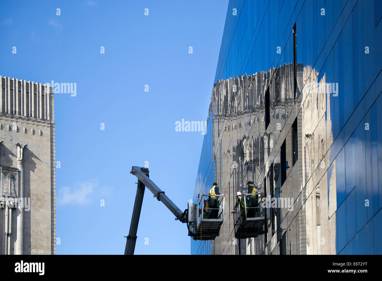 High-Rise window cleaning, using 'Sky king' Wymac elevant 450 on Mann Island, with landmark building reflections,  Liverpool, UK. Stock Photo