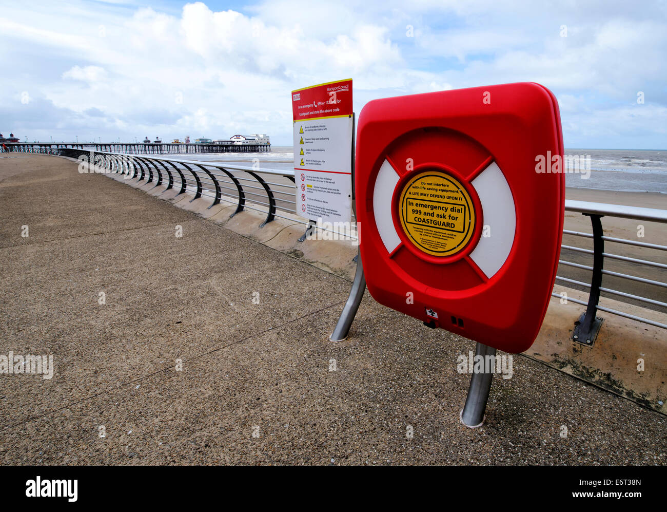 Life belt on the promenade in Blackpool, Lancashire with the North Pier in the background Stock Photo