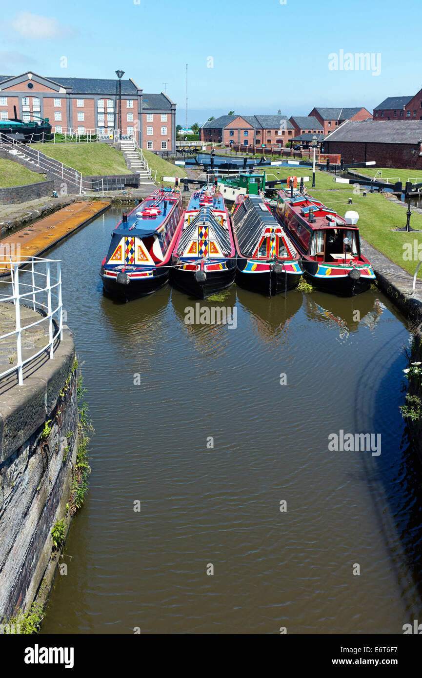 Four narrowboats in lock pool at Ellesmere Port Stock Photo