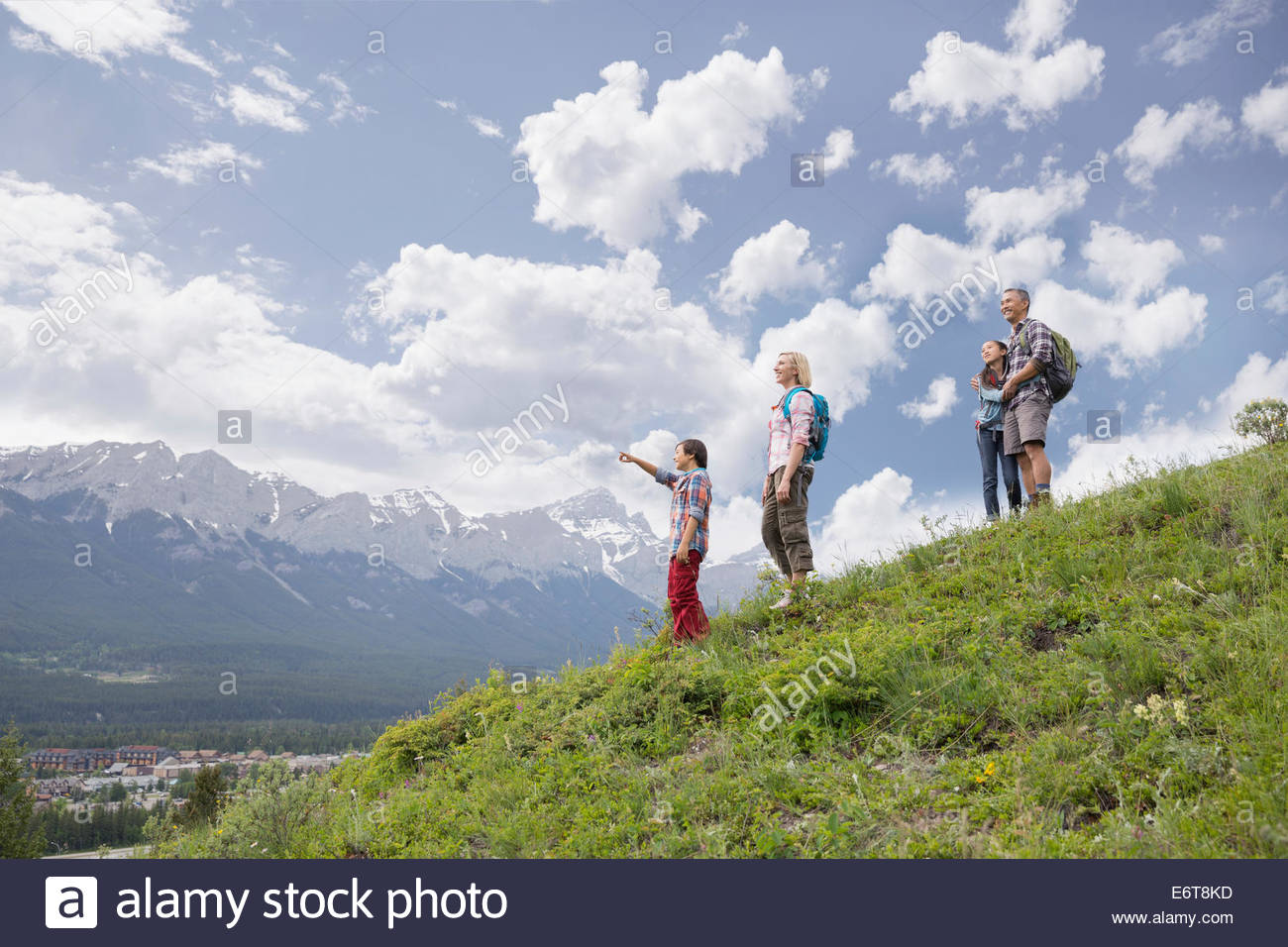 Family overlooking view from rural hillside Stock Photo
