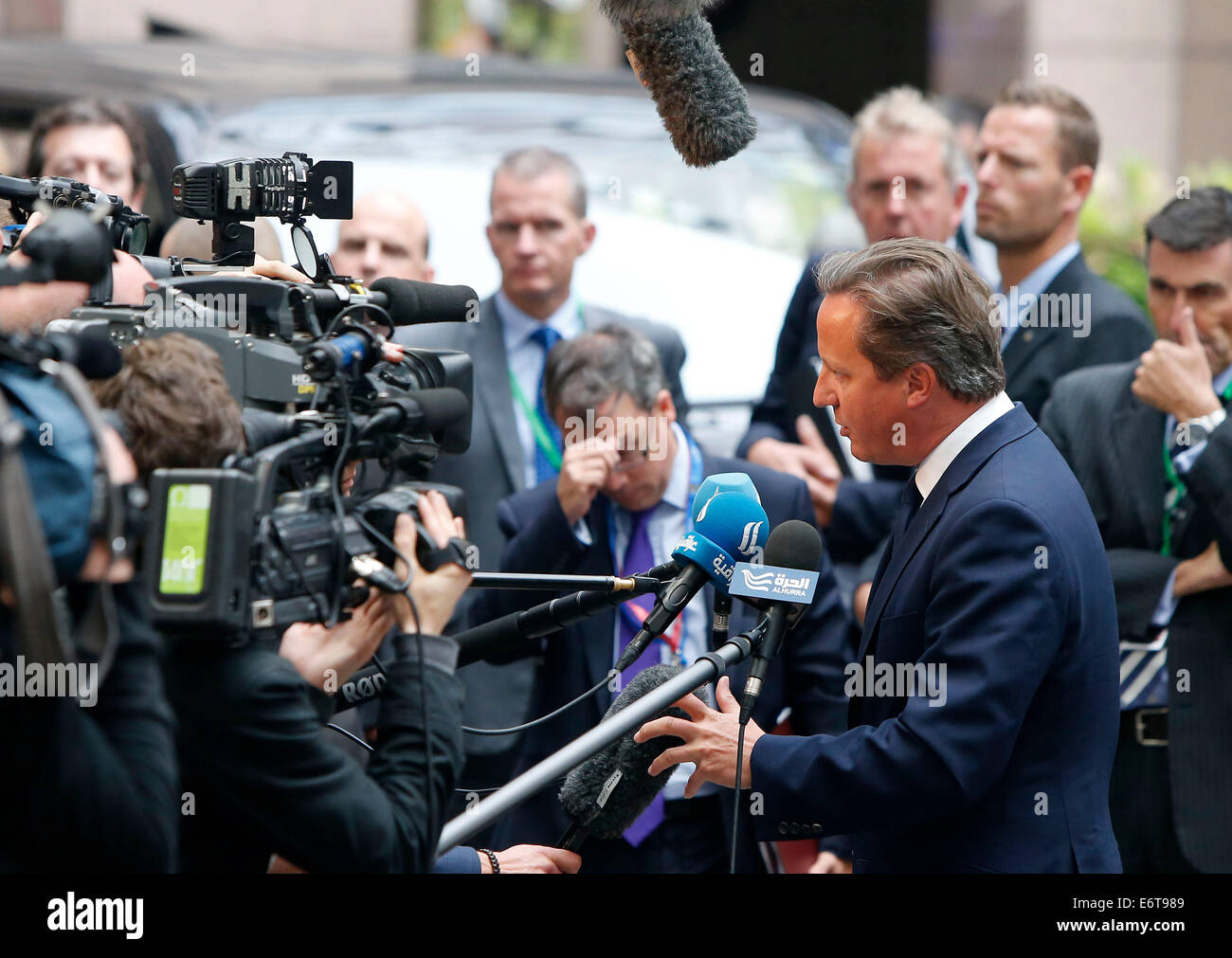 Brussels, Belgium. 30th Aug, 2014. British Prime Minister David Cameron talks to the media while arriving at the European Council headquarters ahead of the European Union (EU) special summit in Brussels, Belgium, August 30, 2014. The support for Ukraine and further sanctions against Russia are expected to top the agenda of the special summit on Saturday. Credit: Zhou Lei/Xinhua/Alamy Live News Stock Photo