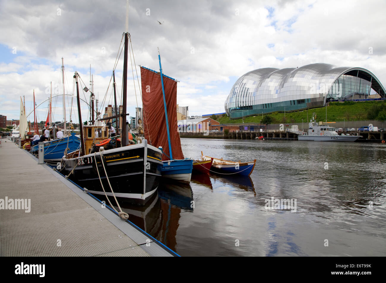 Old sailing boats gathered for a festival at the quayside on the River Tyne in Newcastle. Stock Photo