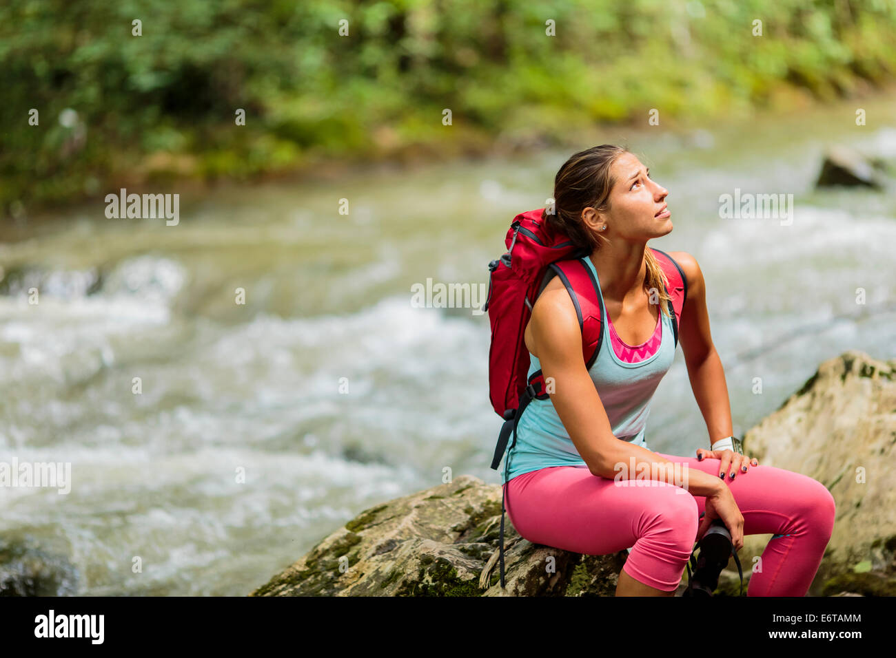 Young woman hiking in the forest Stock Photo - Alamy