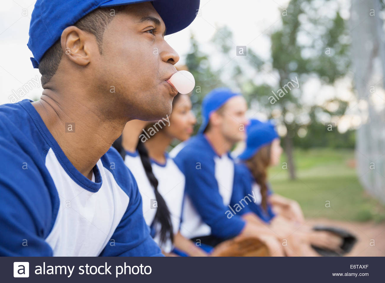 Baseball player blowing bubble gum bubble on field Stock Photo