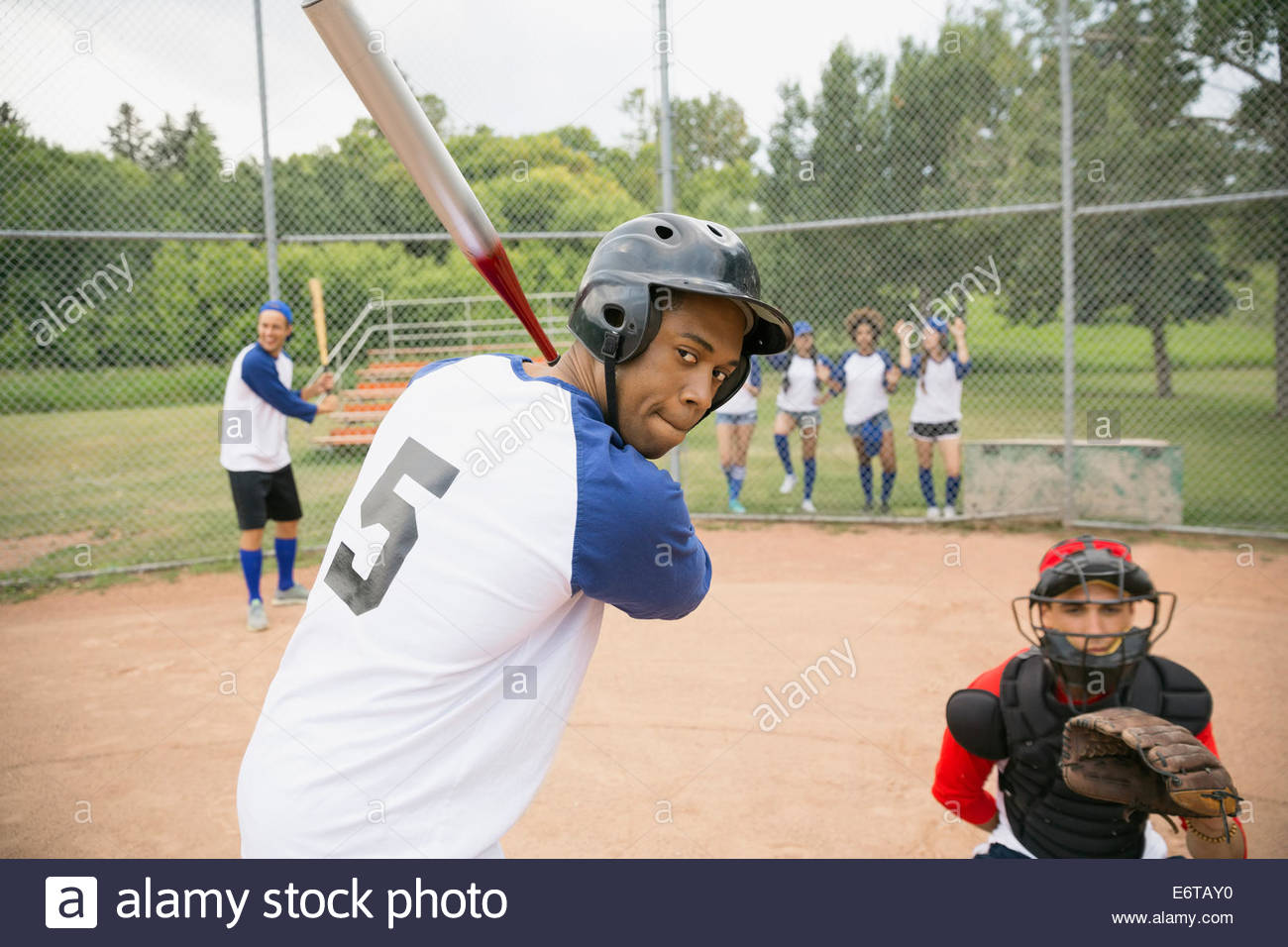 Baseball player ready for ball at home plate Stock Photo