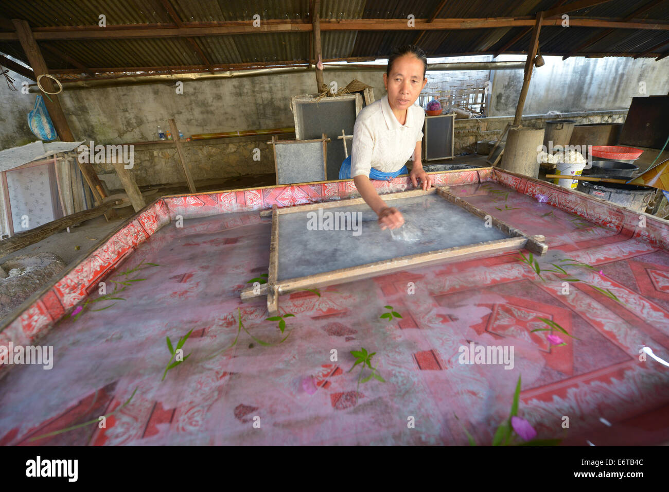 Luang Prabang, Laos March 1, 2014 Woman making Paper made from the