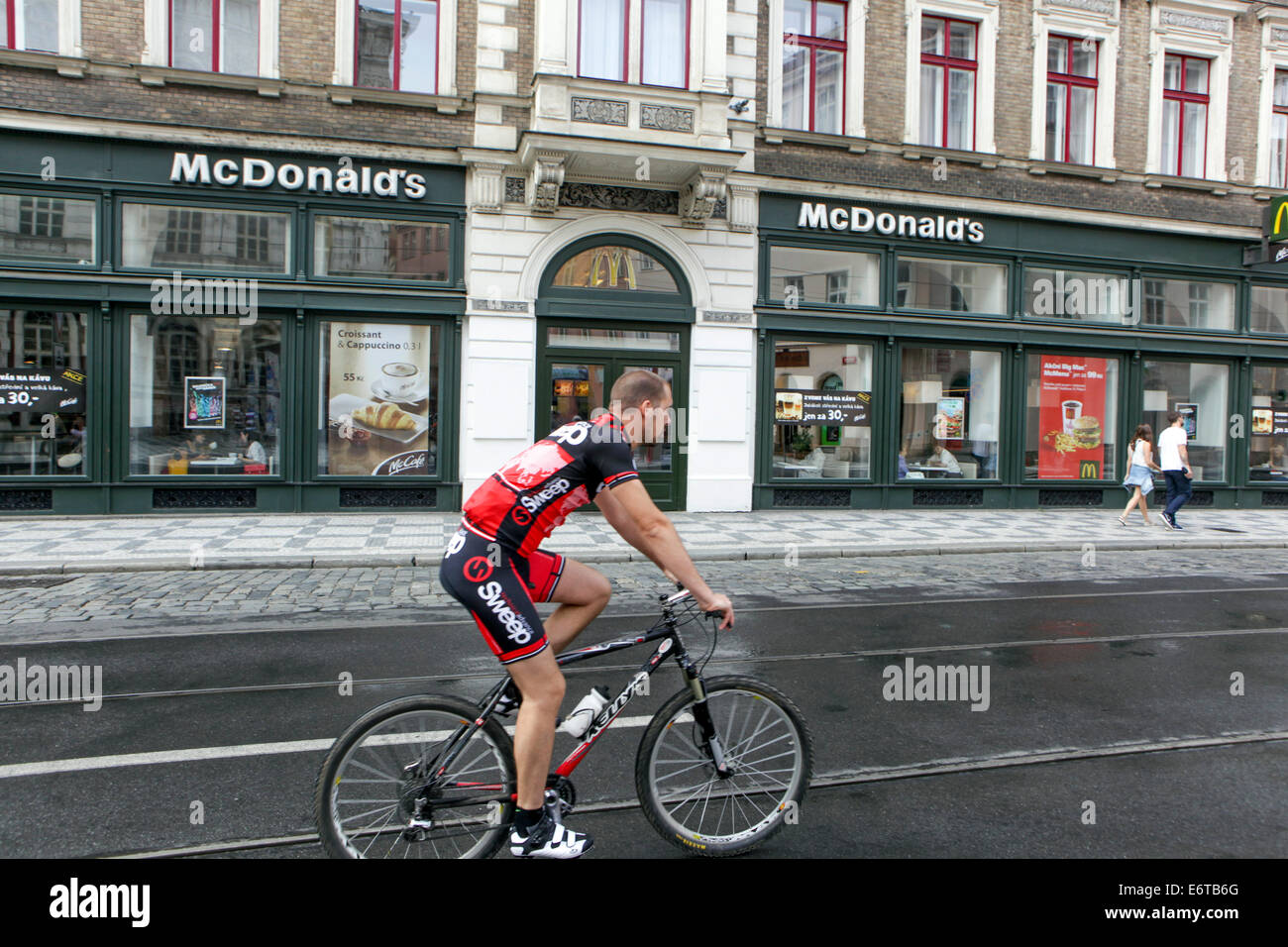 McDonald's fast food in Prague biker, Vodickova street, man ride bike Czech Republic Stock Photo