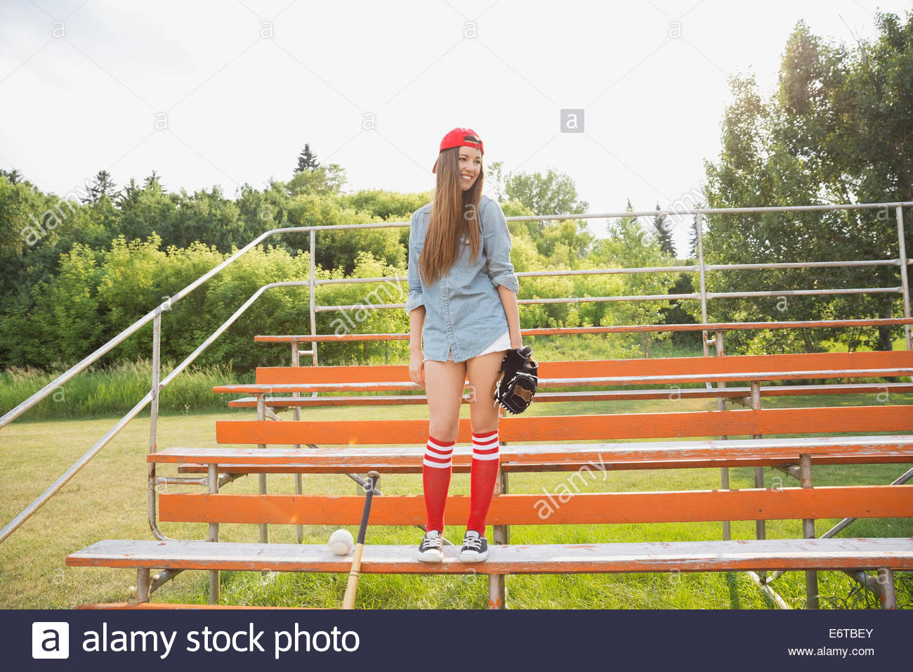 Baseball player standing in bleachers Stock Photo Alamy