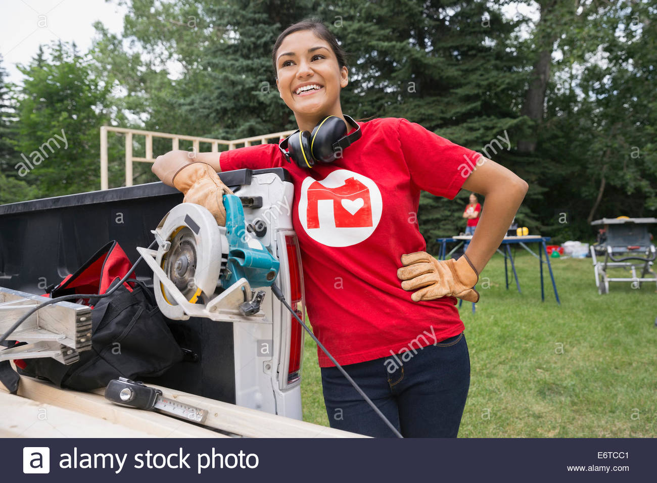 Portrait of confident volunteer with table saw Stock Photo