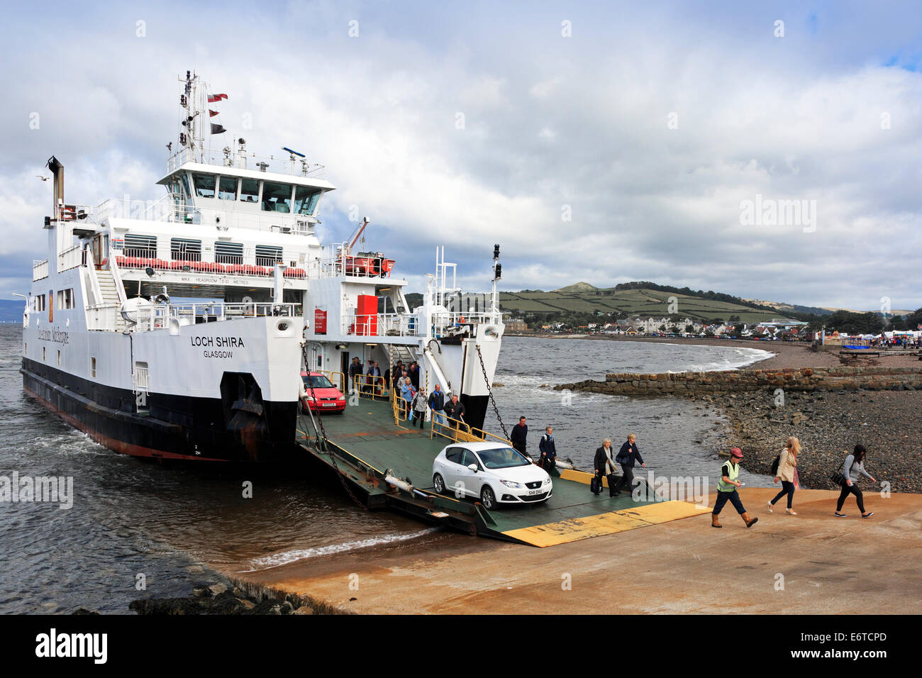 Caledonian MacBrayne ferry traveling from Millport docking at Largs, Firth of Clyde,  with foot passengers and cars Stock Photo
