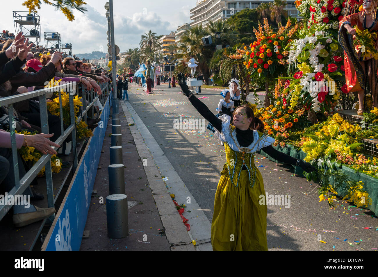 Nice, France, Women in Costume, Throwing Flowers to Crowd on Street at Traditional Spring Carnival parade Stock Photo