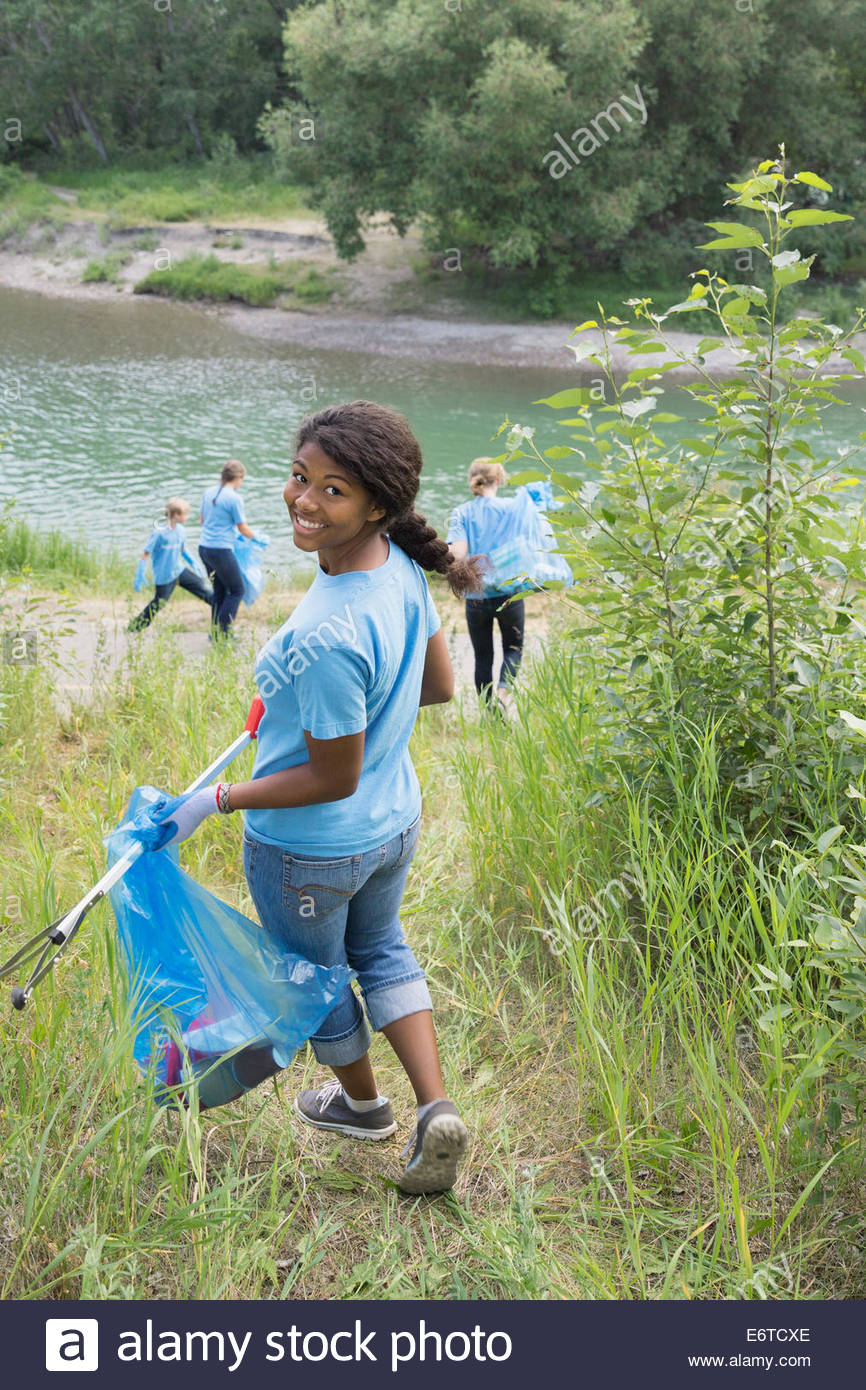 Girl Picking Up Garbage Stock Photos & Girl Picking Up Garbage Stock