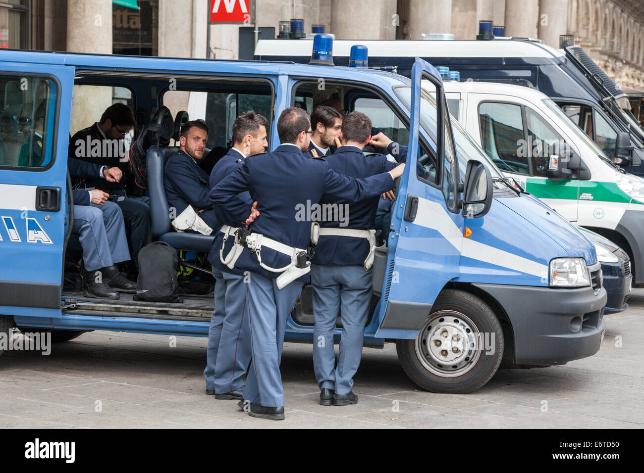 Group of Polizia Italian Policemen around a police van in Piazza Duomo, Milan, Italy Stock Photo