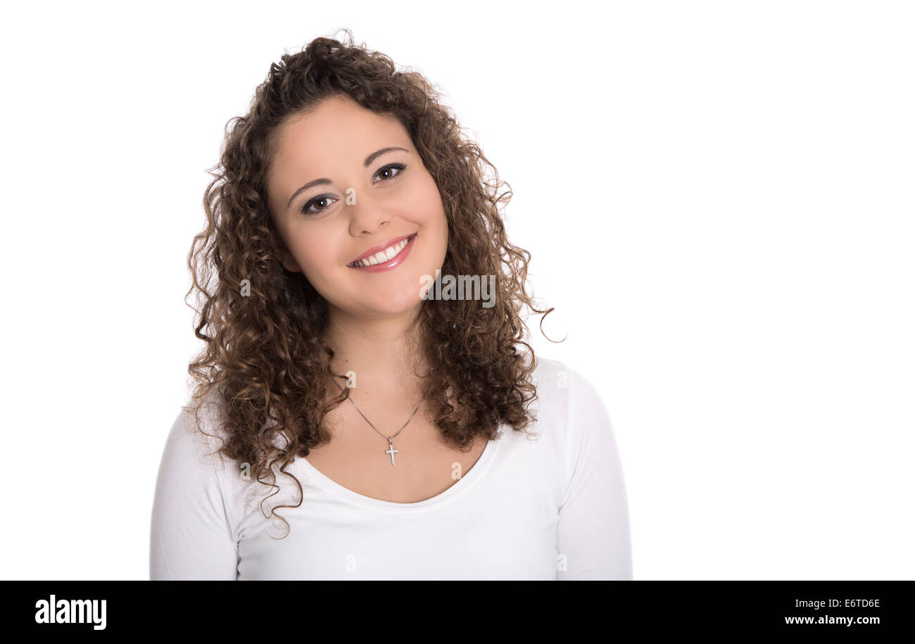 Isolated portrait: smiling brunette young woman or girl in white shirt with curls. Stock Photo