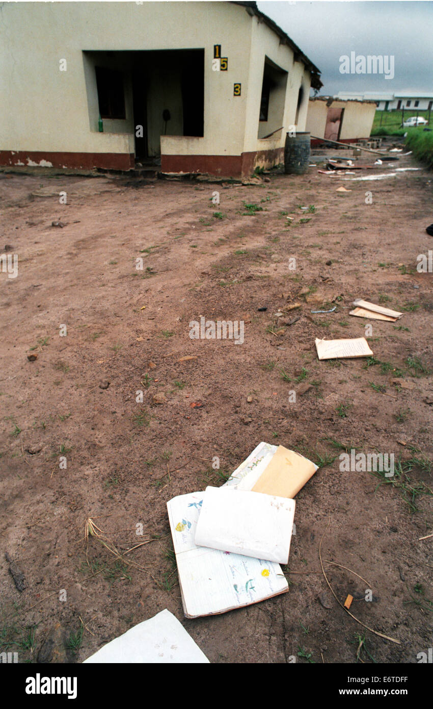 School books lay scattered on the ground next to burned out buildings in the hamlet of Shoboshobane,  1995 Stock Photo