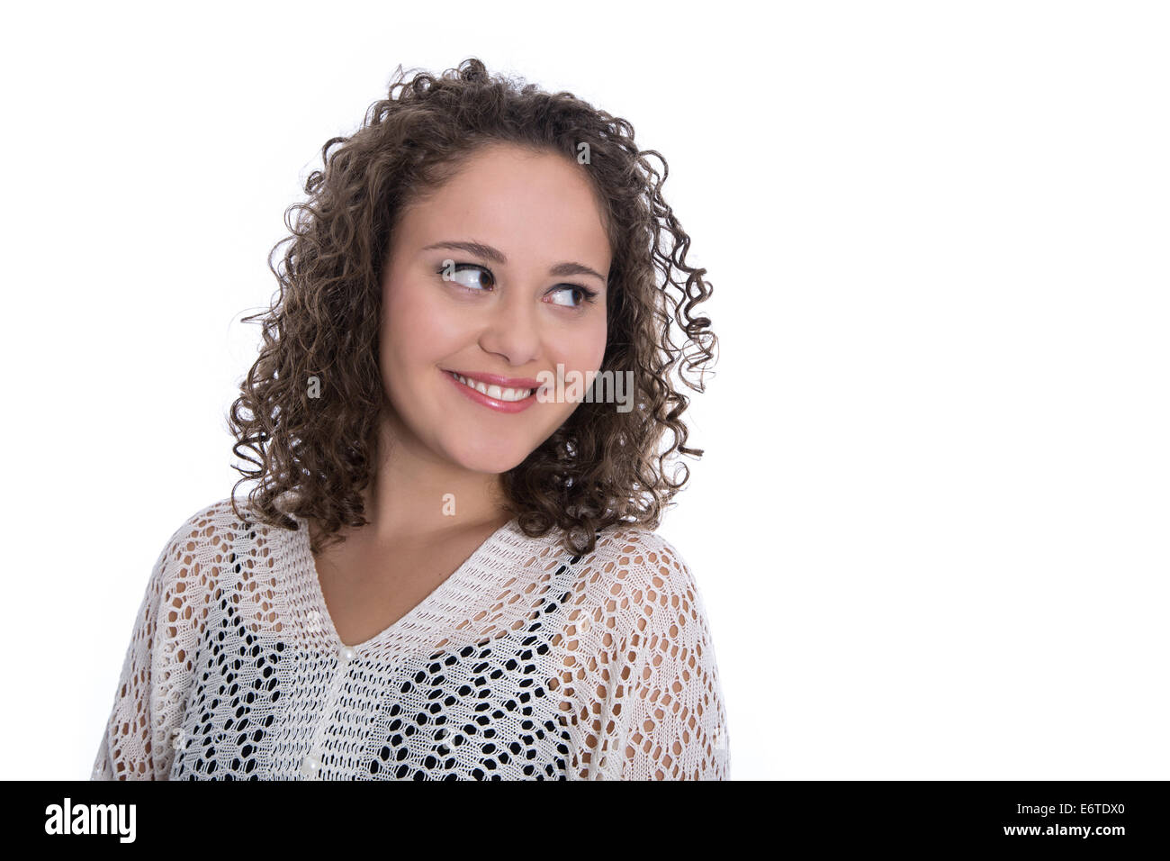 Lovely isolated young woman with curls looking sideways to text. Stock Photo