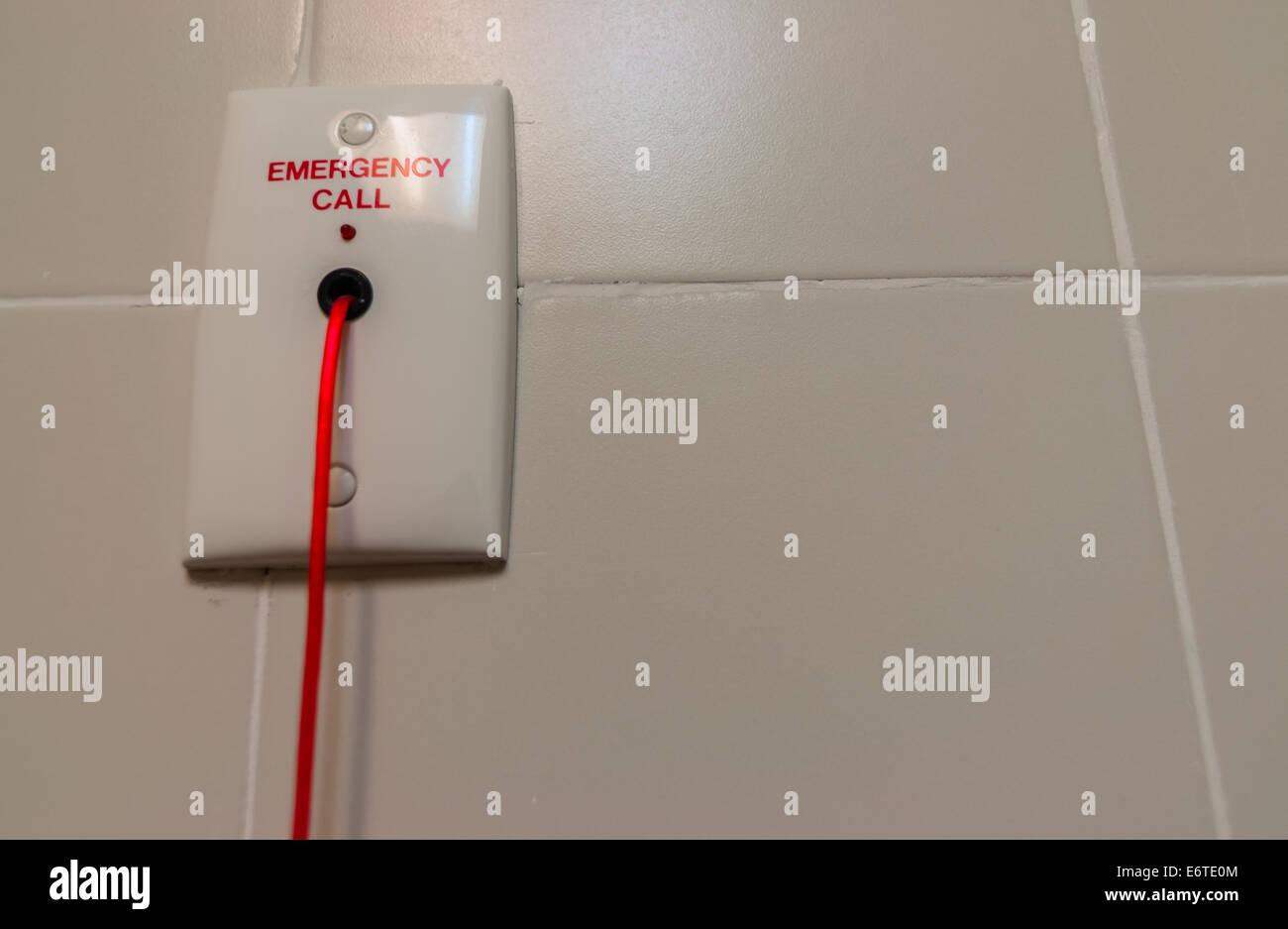 Emergency red rope toilet alarm at hospital Stock Photo