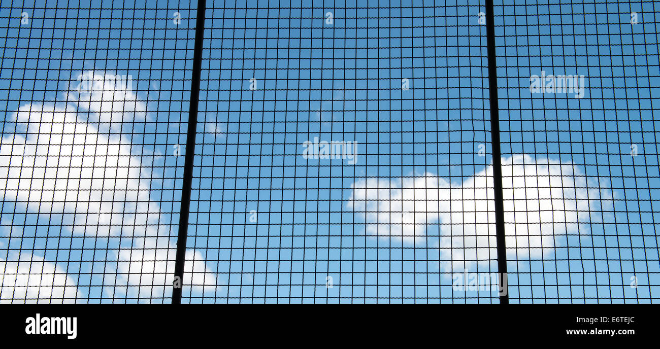 Metal mesh wire fence with blue sky and cloud background Stock Photo ...