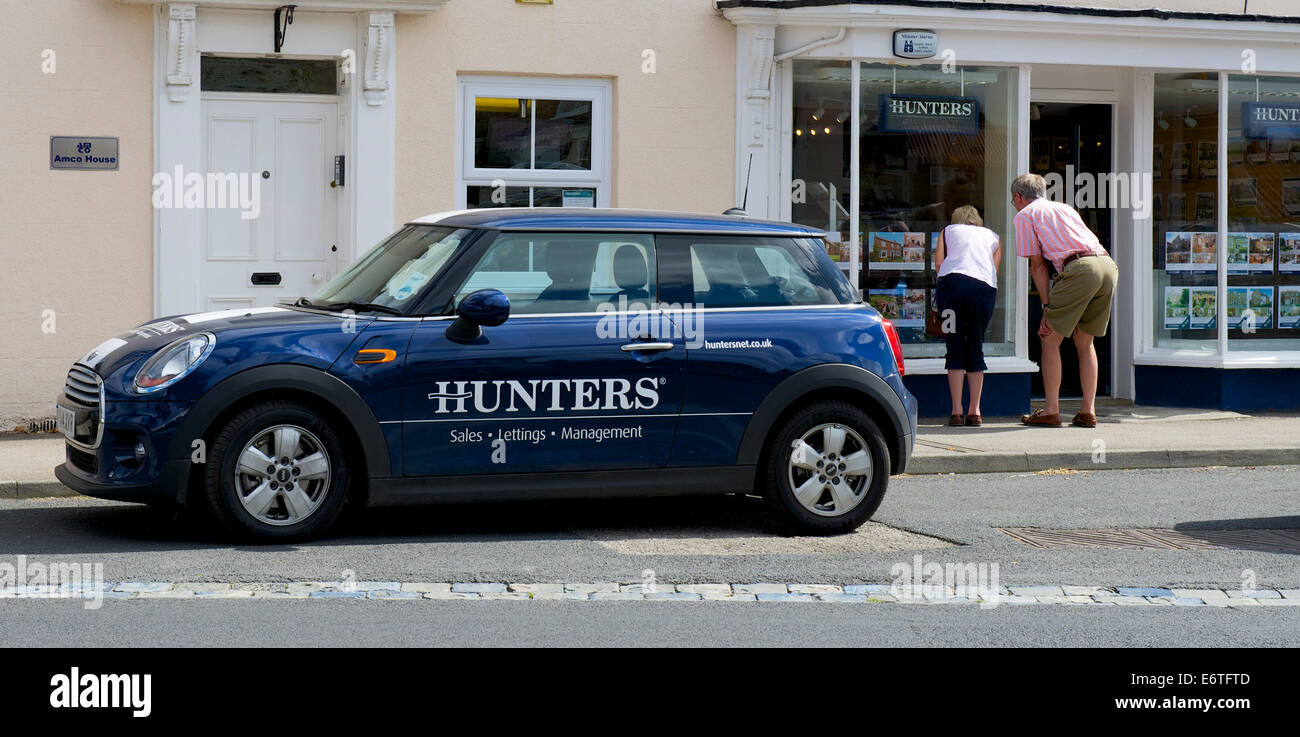 Man and woman looking into window of Hunters, estate agents, Easingwold