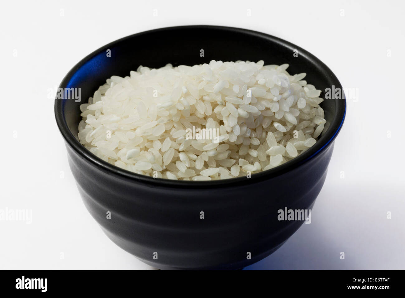 Uncooked white rice in bowl Stock Photo Alamy