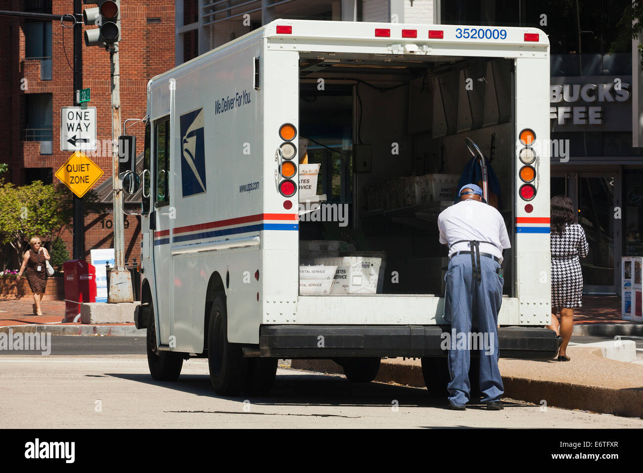 Mailman sorting mail in US Postal Service delivery truck - Washington, DC USA Stock Photo