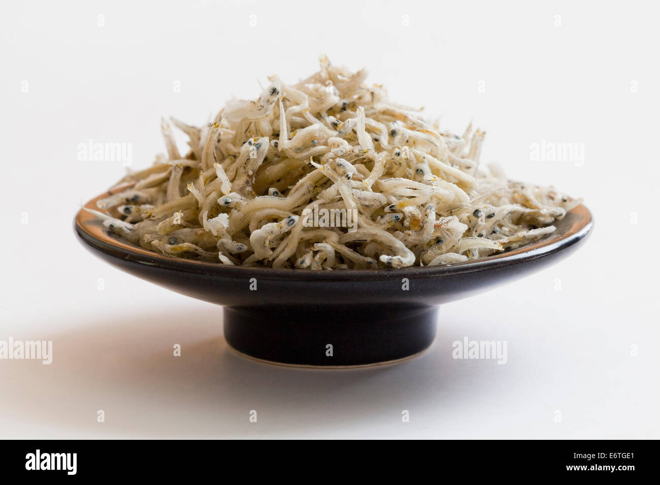 Dried Japanese mini anchovies (Engraulis japonicus) on dish Stock Photo