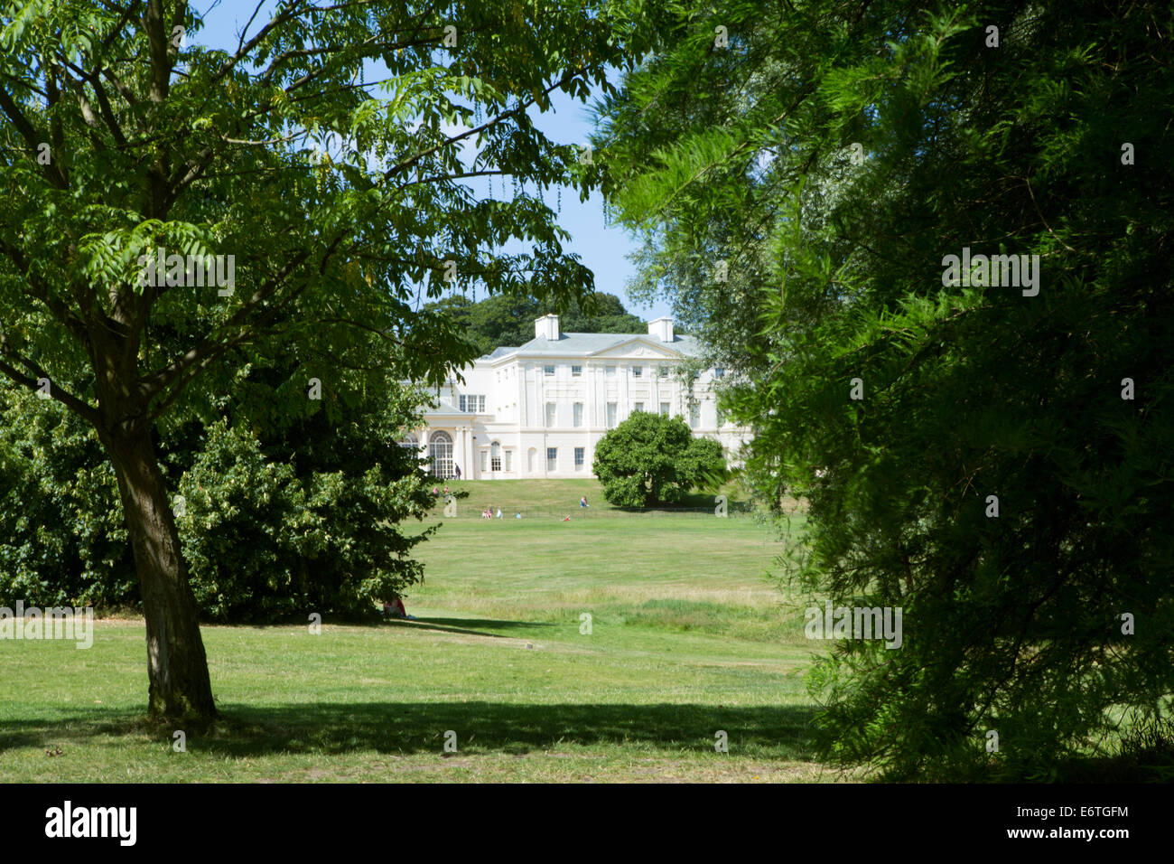 Facade of Kenwood House stately home on Hampstead Heath, through trees on a sunny summer day, Hampstead / Highgate, Borough of Camden, London, UK Stock Photo
