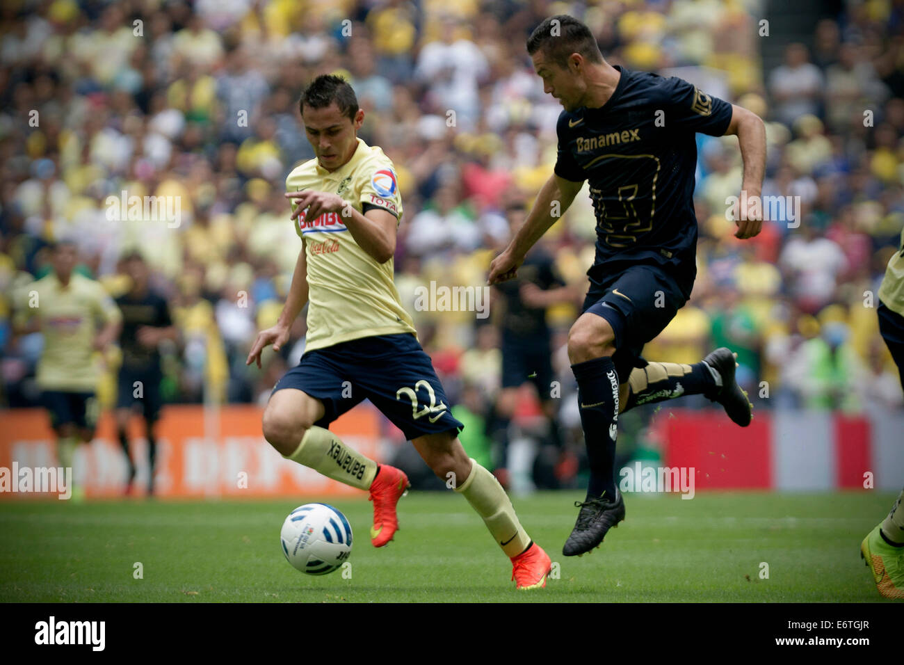 Mexico City, Mexico. 30th Aug, 2014. Paul Aguilar (L) of America vies for the ball with Dante Lopez of UNAM's Pumas during their match of the MX League Opening Tournament 2014, held at Azteca Stadium, in Mexico City, capital of Mexico, on Aug. 30, 2014. Credit:  Alejandro Ayala/Xinhua/Alamy Live News Stock Photo