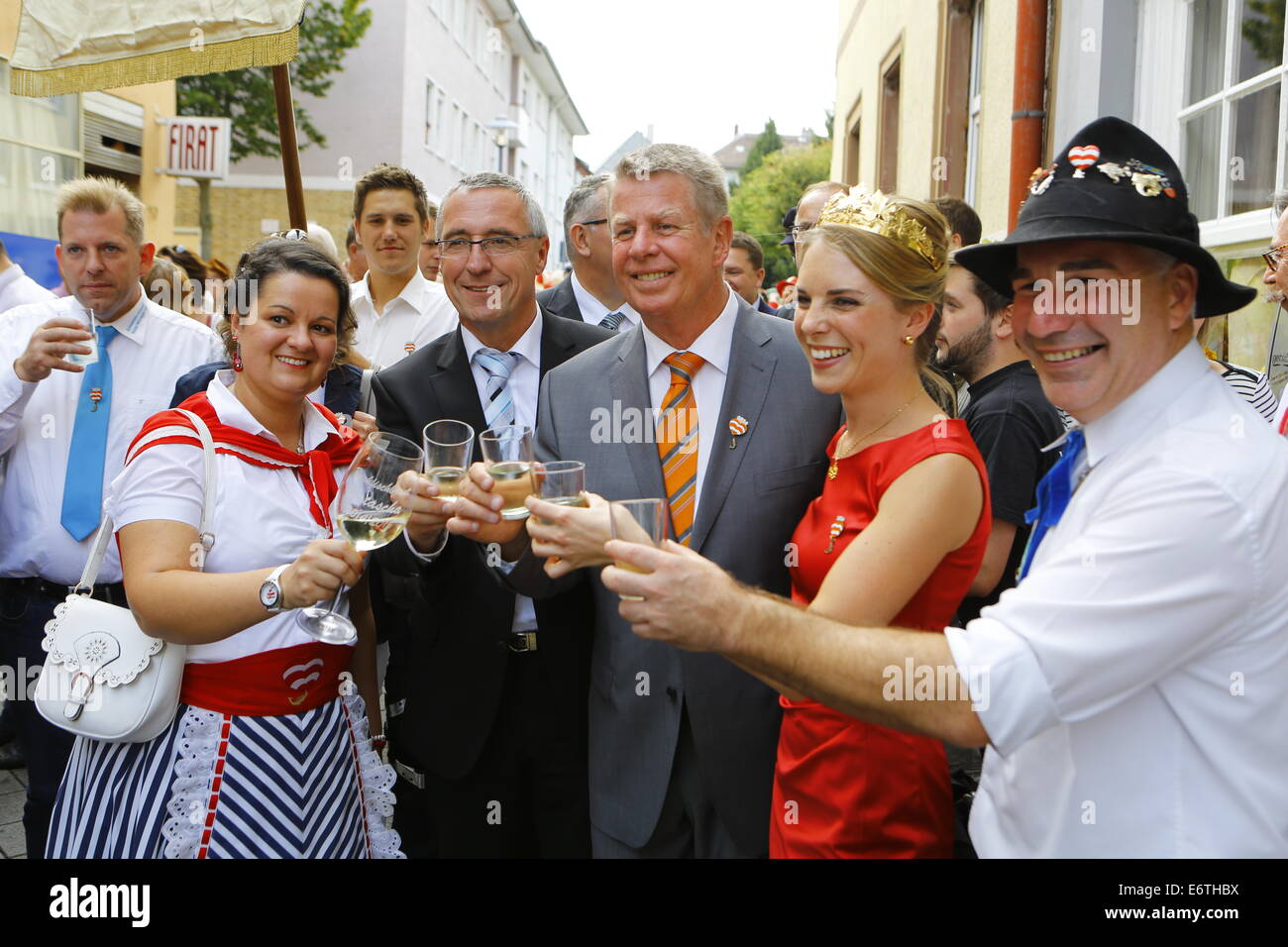 Germany. 30th Aug, 2014. The BojemŠŠschter vun de FischerwŠŠd (mayor of the fishermenŠs lea), Markus Trapp (right), his bride Natascha Schlereth (left), the Secretary of State of the Ministry of the Interior of Rhineland-Palatinate, GŸnter Kern (2nd left), Lord Mayor of Worms, Michael Kissel (3rd left) and the Rhine-Hessian wine queen Judith Dorst (2nd right) pose with a glass of wine. The Backfischfest started in Worms with the traditional handing over of power from the Lord Mayor to the Mayor of the FishermenÕs Lea. Credit:  Michael Debets/Pacific Press/Alamy Live News Stock Photo