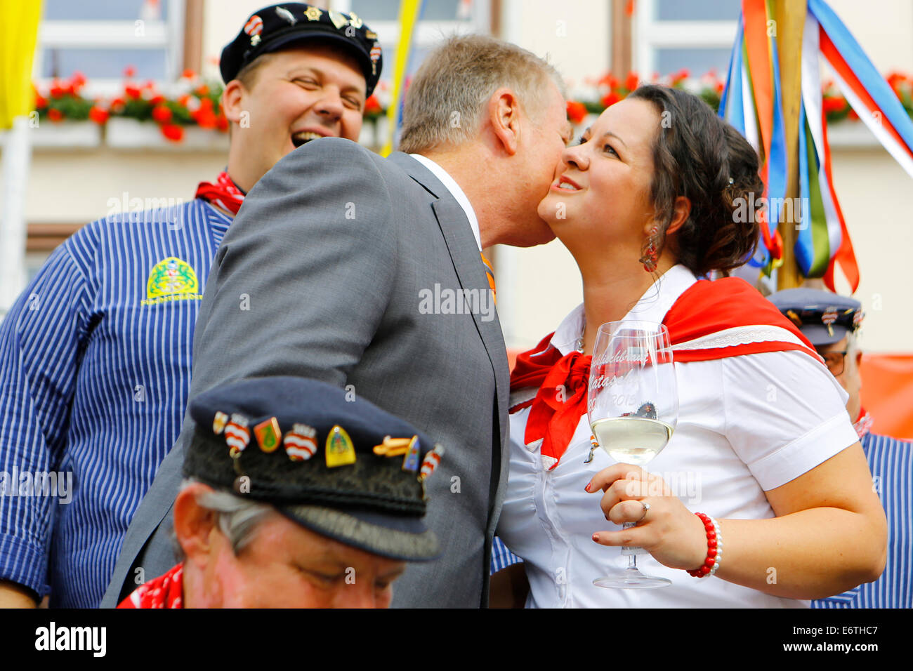 Germany. 30th Aug, 2014. The Lord Mayor of Worms, Michael Kissel (left), kisses the Backfish bride Natascha Schlereth (right). The Backfischfest started in Worms with the traditional handing over of power from the Lord Mayor to the Mayor of the FishermenÕs Lea. It is the largest wine fair along the Rhine that includes music and dances. Credit:  Michael Debets/Pacific Press/Alamy Live News Stock Photo