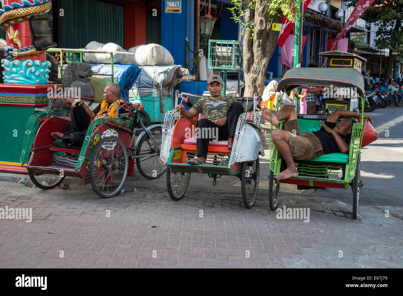 Yogyakarta, Java, Indonesia.  Becak (three-wheeled, man-powered rickshaws) Drivers Waiting for Passengers. Stock Photo