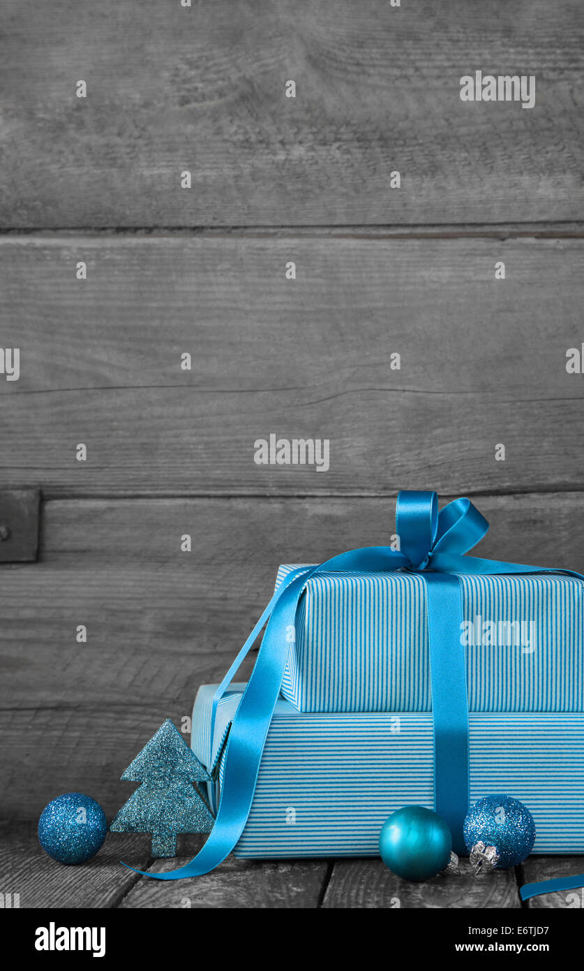 Wooden grey shabby chic christmas background with presents in blue or turquoise. Stock Photo