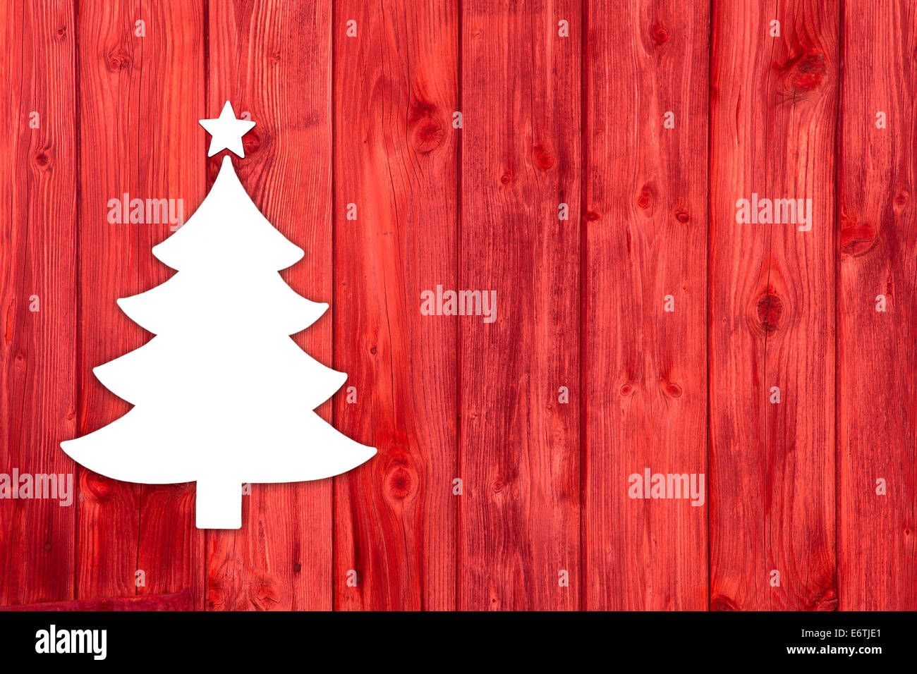 Red wooden christmas background with a white tree. Idea for a xmas card. Stock Photo