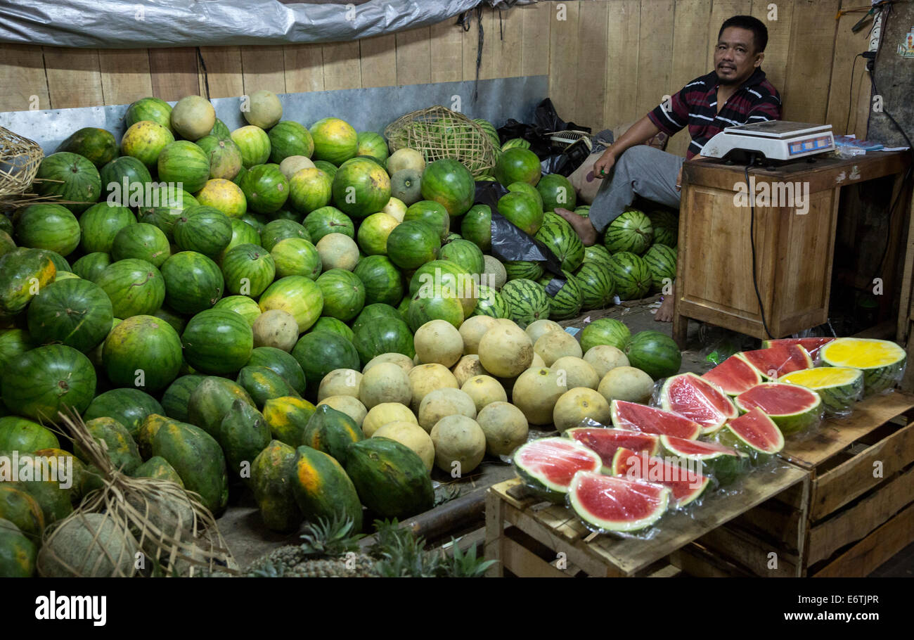 Yogyakarta, Java, Indonesia.  Man Selling Watermelons and Papayas, Beringharjo Market. Stock Photo