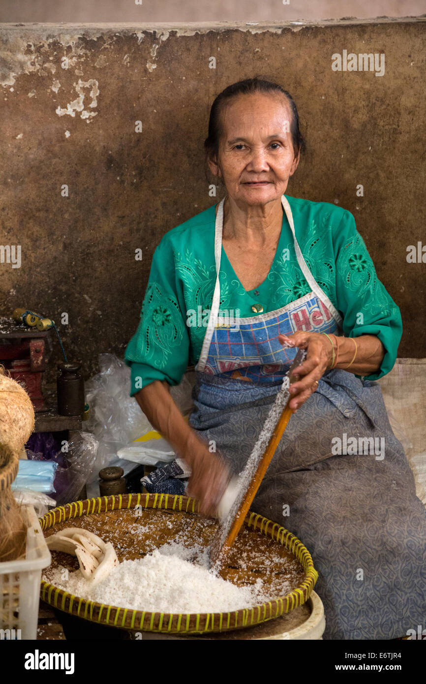 Yogyakarta, Java, Indonesia.  Woman Grating Coconut, Beringharjo Market. Stock Photo