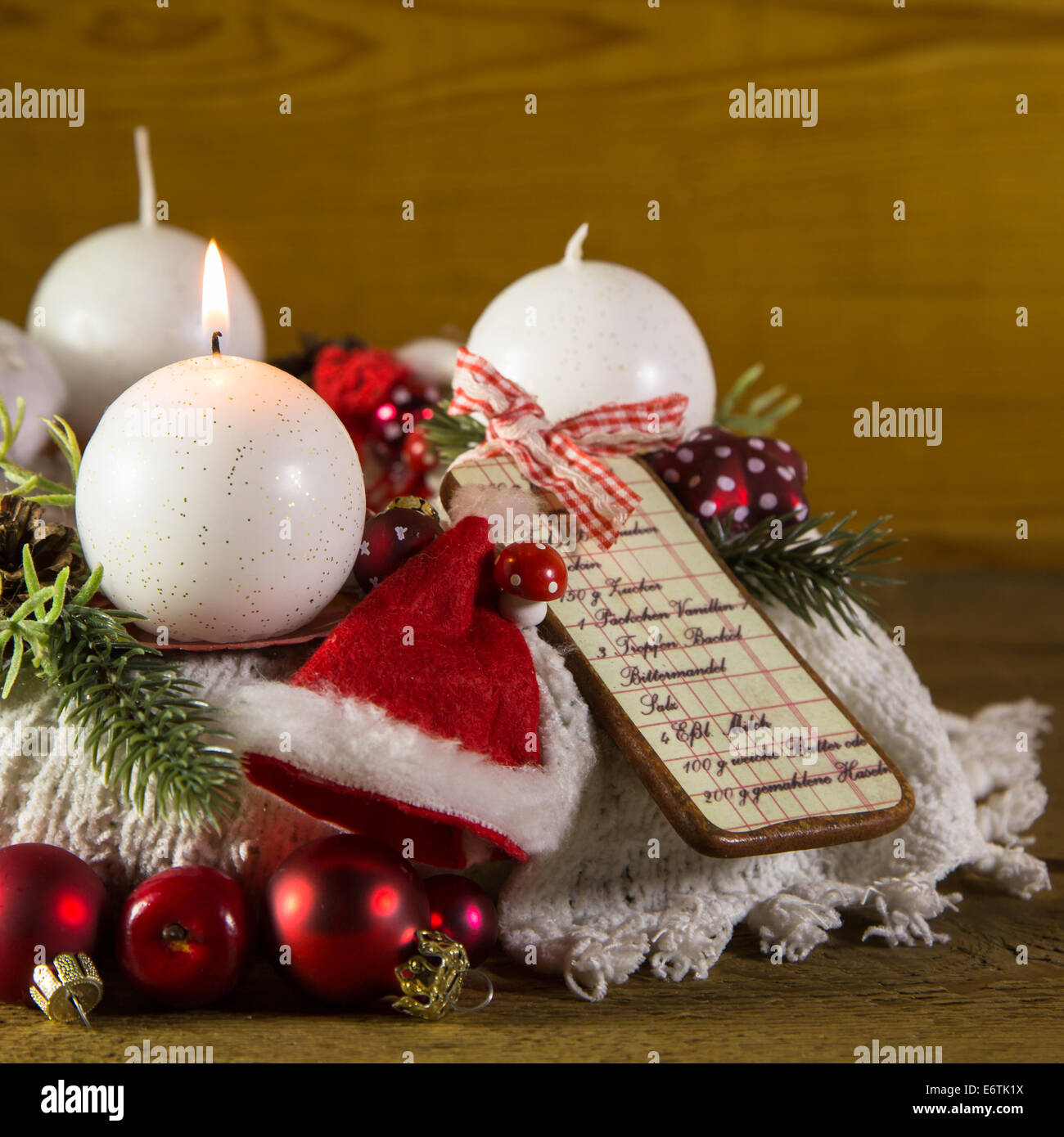 First advent with one red burning candle on the wreath. Stock Photo