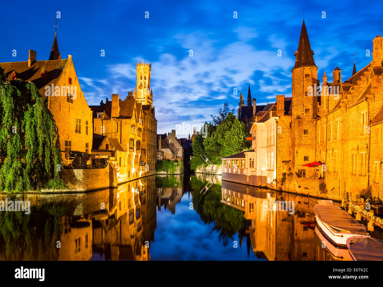 Bruges, Belgium. Image with Rozenhoedkaai in Brugge, Dijver river canal twilight and Belfort (Belfry) tower. Stock Photo
