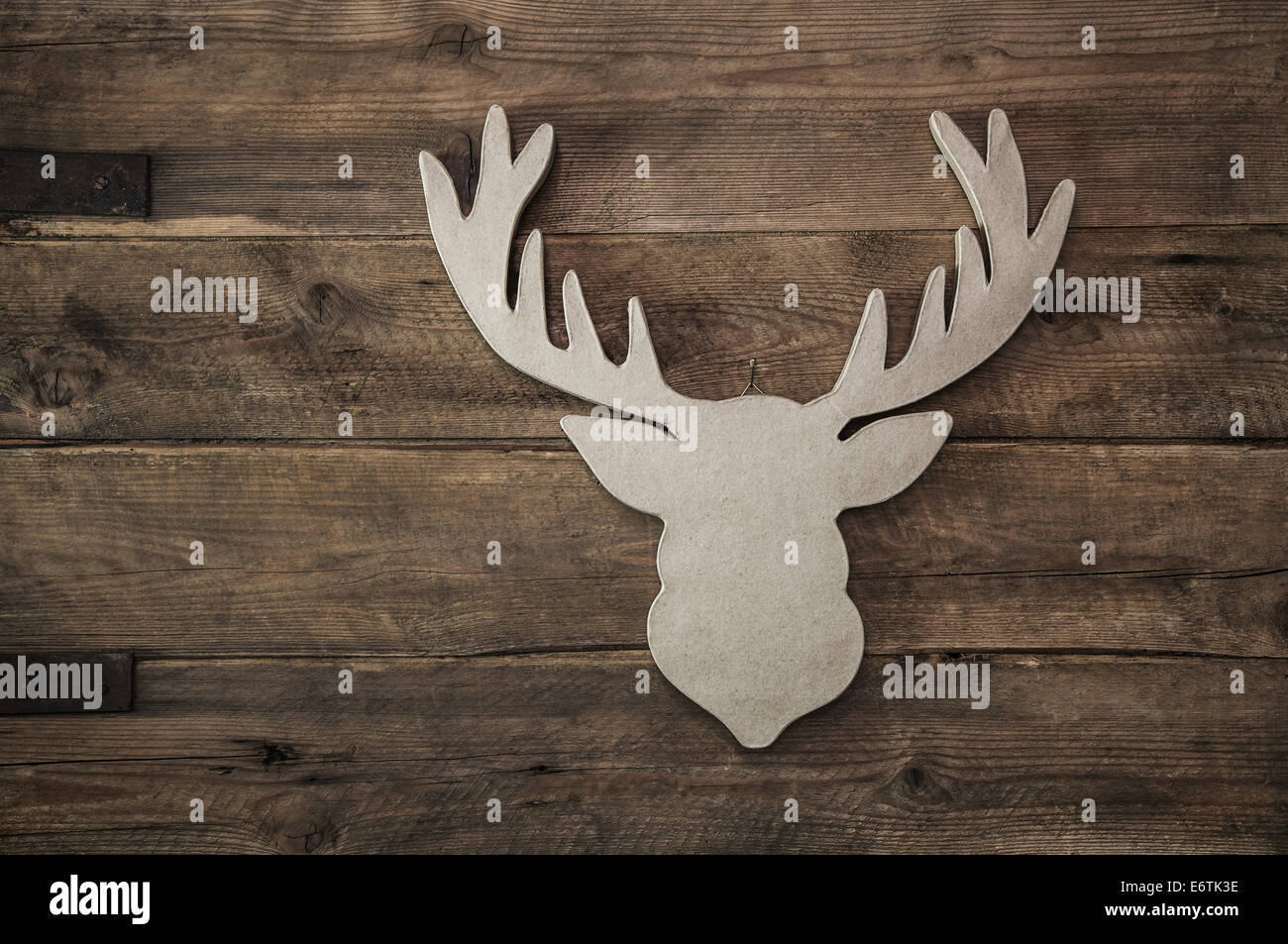 Vintage rustic christmas decoration with antler on wooden brown background. Stock Photo