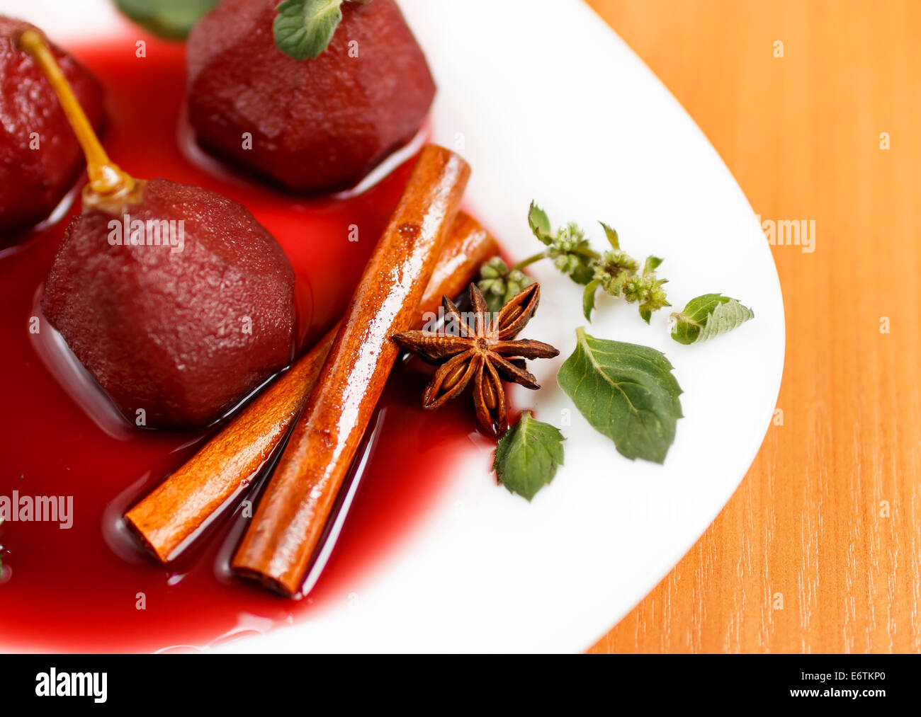 cinnamon sticks and star anise in fruity dessert, pears in red wine Stock Photo