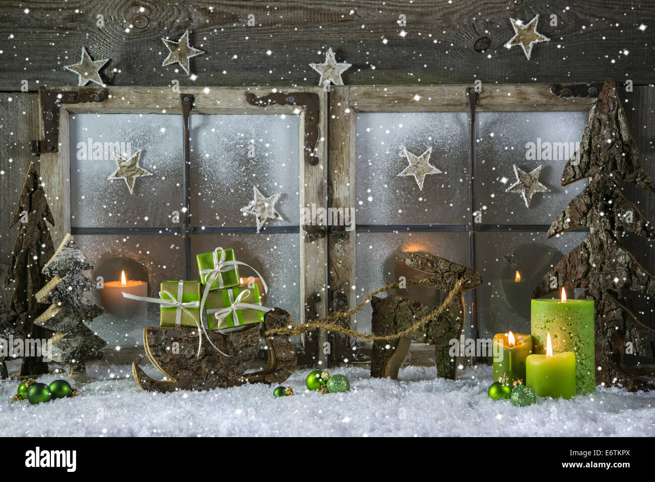 Natural wooden christmas decoration with candles and green gift boxes. Stock Photo