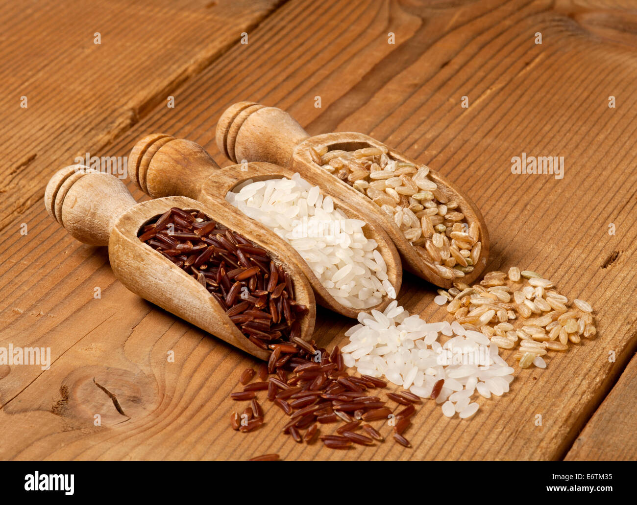 Slops Food Rice Wooden scoops with different rice types scattered on wooden background ...