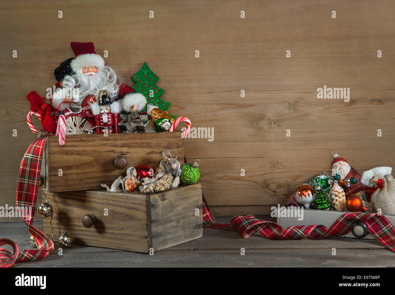 Old colorful christmas decoration with santa on wooden old background. Stock Photo