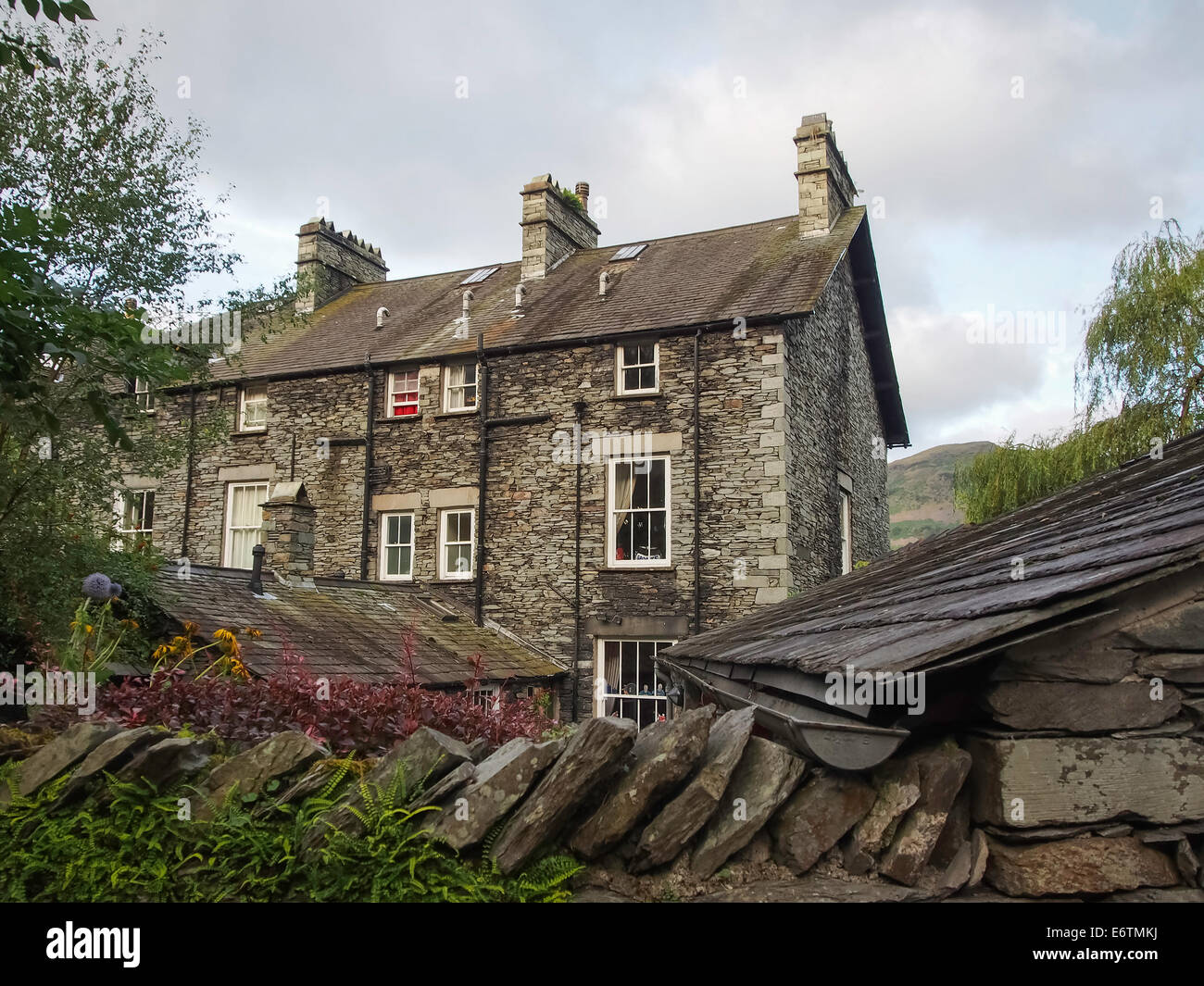 a rear view of traditional stone houses in the village of grasmere in
