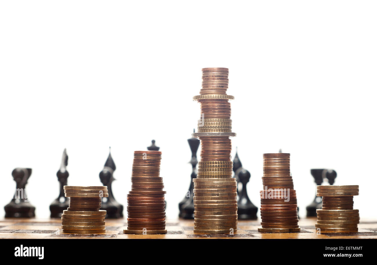 Euro or dollar coins stacked like a king, officers and rooks on a chess board on a white background. Stock Photo