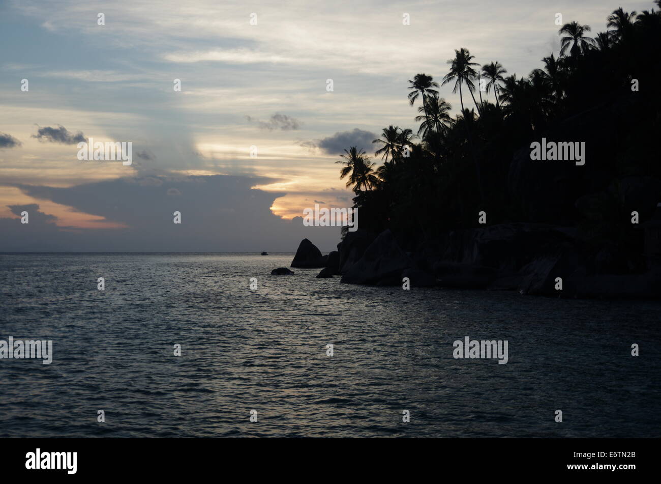 Sunset on the sea and an island in the dark. Stock Photo