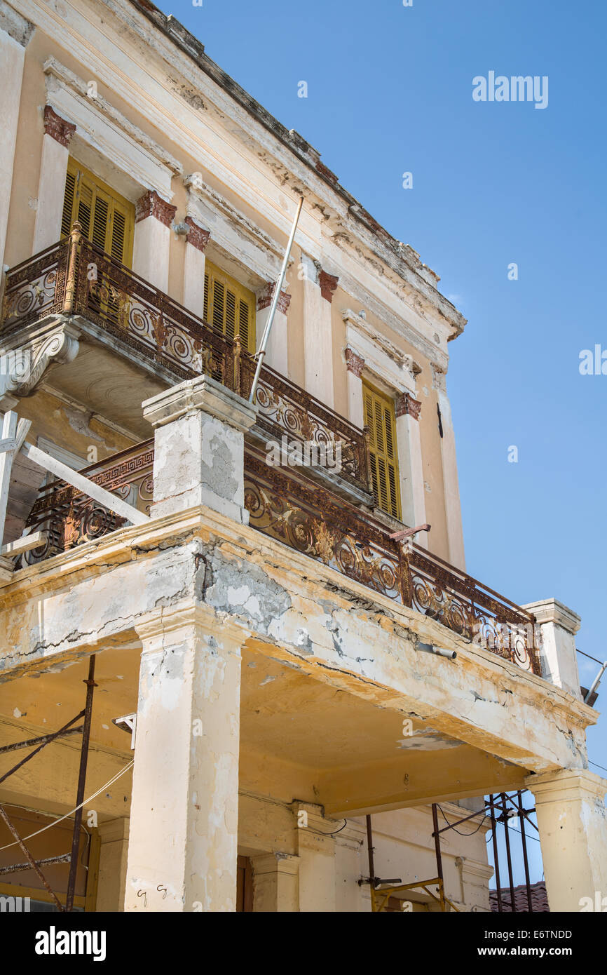 Old broken balcony on a old house with rust and broken wall. Stock Photo