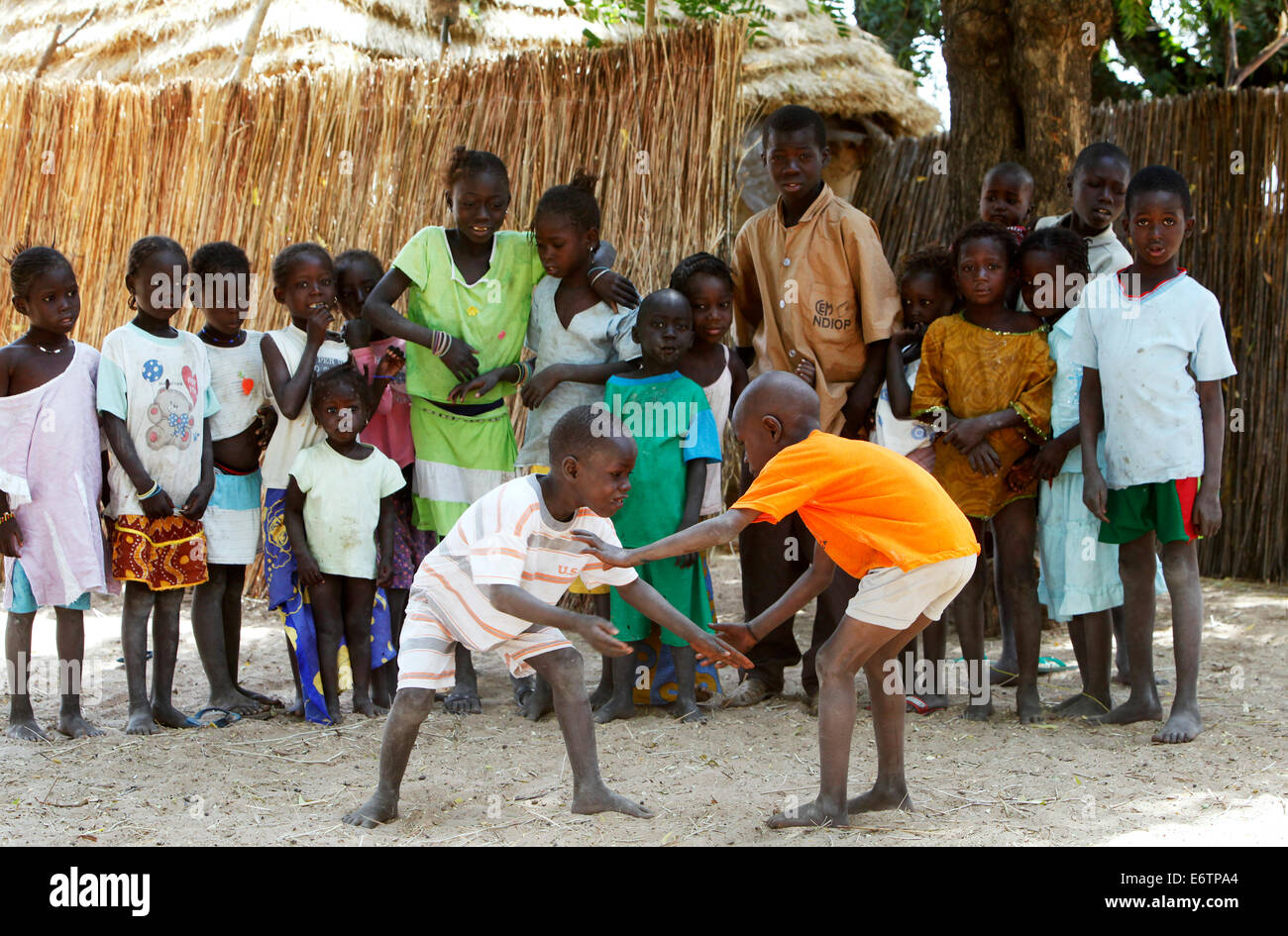 Children carry out a wrestling match. Wrestling is the senegalese national sport. Senegal, Africa Stock Photo