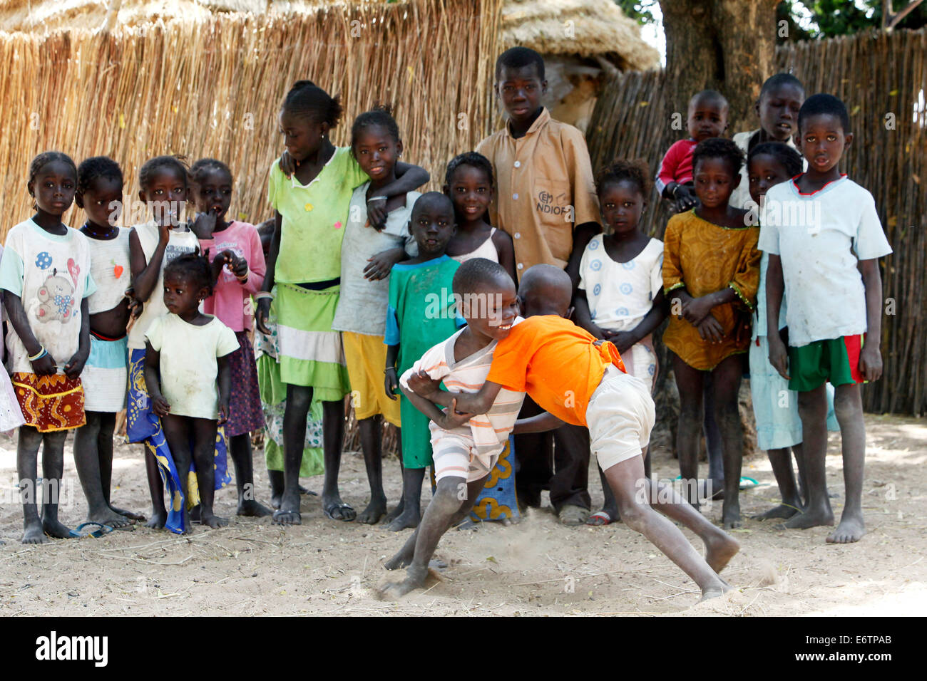 Children carry out a wrestling match. Wrestling is the senegalese national sport. Senegal, Africa Stock Photo